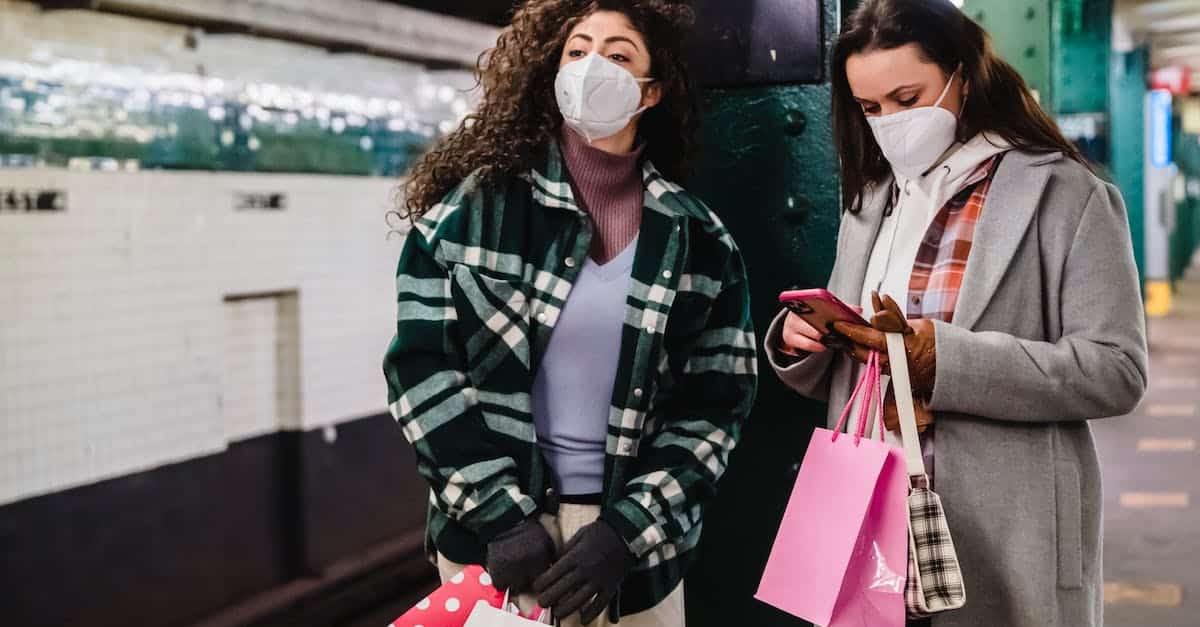female-in-protective-mask-using-mobile-phone-while-waiting-for-train-on-platform-of-subway-station-w-2