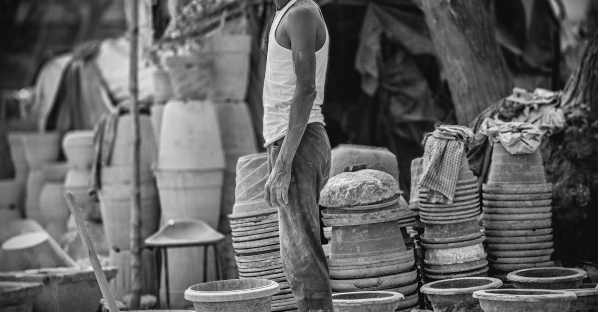a-man-stands-in-front-of-a-pottery-shop