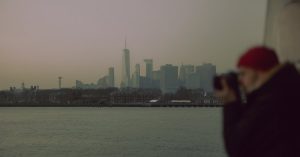 a-man-taking-a-photo-of-the-city-skyline
