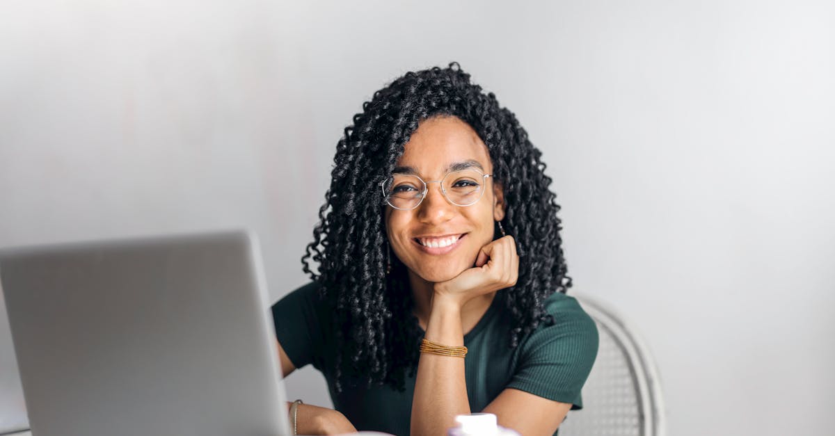 happy-ethnic-woman-sitting-at-table-with-laptop-10