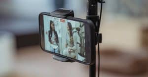 modern-smartphone-on-tripod-recording-video-of-content-stylish-women-having-friendly-conversation