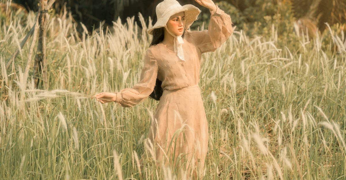 woman-in-hat-among-grass-in-field